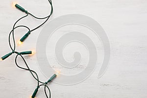Christmas garland lights on old wooden shabby background