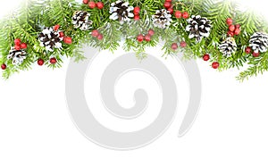 Christmas garland of snowy fir branches decorated with cones, red berries on a white background.Copy space