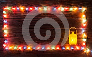 Christmas garlands of lamps on a wooden background.