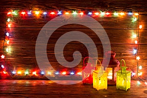 Christmas garlands of lamps on a wooden background.
