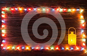 Christmas garlands of lamps on a wooden background.