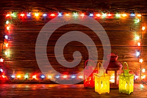 Christmas garlands of lamps on a wooden background.