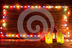 Christmas garlands of lamps on a wooden background.