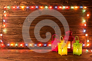 Christmas garlands of lamps on a wooden background.