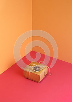 Christmas geometric composition. Craft gift boxes and slice of dry orange on pastel sand color background