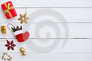 Christmas gif boxes, snow flake, red sock, christmas ball and candy cane on white wooden board. photo