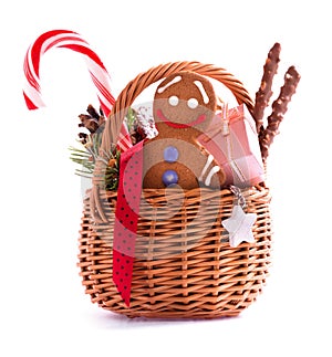 Christmas gift basket with treats and gingerbread man isolated