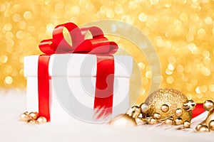 Christmas gift box against gold bokeh background