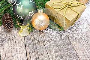 Christmas gift box and decoration over grunge wooden background