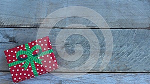 Christmas gift box laying on a rustic wood background