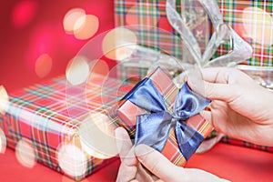 Christmas gift box at red background with magical lights star