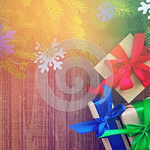 Christmas gift box with red ribbon on wooden background, many Christmas presents with decorations