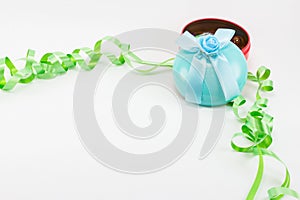 Christmas gift box with ribbon and color plastic balls.