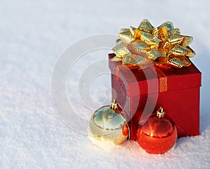 Christmas Gift Box with Shiny Balls on Snow. Outside.