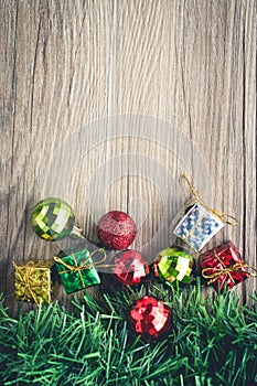 Christmas gift boxes and balls background on wooden texture