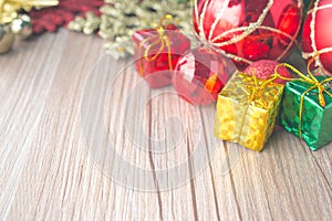 Christmas gift boxes and balls background on wooden texture