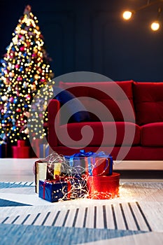 Christmas gift boxes with chistmas tree lights on background.