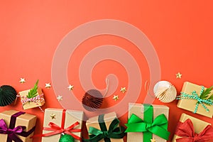 Christmas gift boxes with colorful ribbons on red background. Holiday wrapping and packaging concept. Top above. Flat lay
