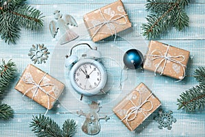 Christmas gift boxes decoration and alarm clock on wooden background