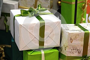 Christmas gift. boxes with gifts, tied with a ribbon with a bow. in beige and green colors scheme. New Year gifts.