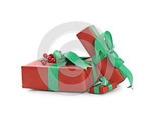 Christmas gift boxes with green bows and berries on white background