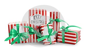 Christmas gift boxes with green bows and berries on white background