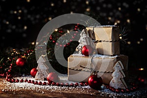 Christmas gift boxes in kraft paper decorated with red baubles,
