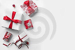 Christmas gift boxes with red ribbon and decoration on white background.