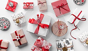 Christmas gift boxes with red ribbon and decoration on white background. Xmas and Happy New Year holiday. Flat lay, top viewÑŽ