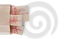 Christmas gift boxes with striped red and white baker's twine paper bag isolated on white background