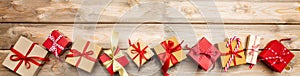 Christmas gift boxes on wooden background, banner, copy space, top view