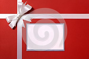 Christmas gift card or label and envelope, white ribbon bow, red