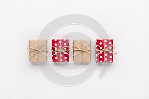 Christmas gift composition. New year flatly with red dotted and craft gifts at grey background. Xmas concept