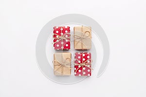 Christmas gift composition. New year flatly with red dotted and craft gifts at grey background. Xmas concept