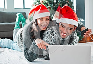 Christmas, gift and couple online shopping in home with credit card for sale, discount or payment. Xmas, promotion and