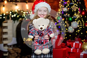 Christmas gift she dreamed about. Best gift ever. Happy new year concept. Dreams come true. Kid near christmas tree hold