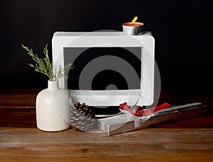 Christmas gift with empty picture frame on wooden table