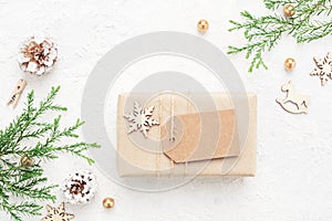 Christmas gift with empty tag & New Year`s decorations on white.