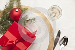 Christmas Gift with Festive Place Setting at Elegant Dining Table