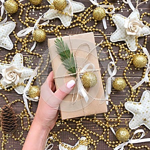 Christmas present on a wooden background with gold and candy