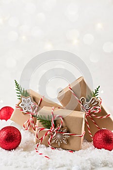 Christmas gift or present box wrapped in kraft paper with decoration on white background. Present decorated with natural parts.