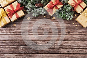 Christmas gift or present boxes with holiday decorations and snowy fir tree on wooden table top view