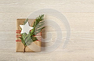 Christmas gift present wrapped in sustainable recycled wrapping paper with fresh evergreens natural decorations