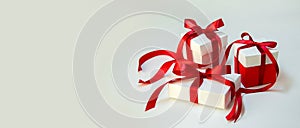 Christmas Gift`s in White Box with Red Ribbon on Light Background. New Year Holiday Composition Banner. Copy Space For Your Text