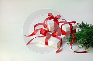 Christmas Gift`s in white box with red ribbon on light background. New year holiday composition. Copy space