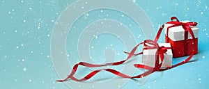 Christmas Gift`s in White Box with Red Ribbon on Light Blue Background. New Year Holiday Composition Banner. Copy Space