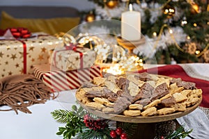 Christmas gift table set with gingerbread and candle with garland lights