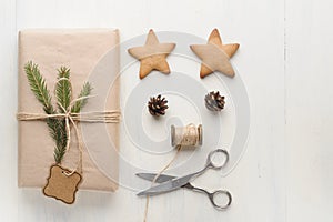 Christmas gift, thread, scissors, pine cone, pine needles.