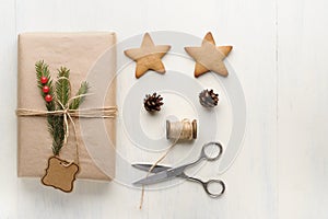 Christmas gift, thread, scissors, pine cone, pine needles.