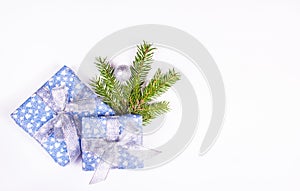 Christmas gift on white background with spruce branch. Shiny gift boxes on white background.